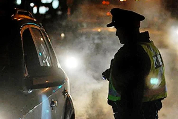 Police checking vehicle at night